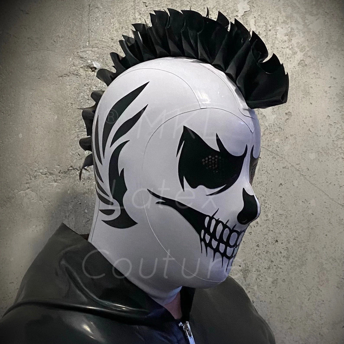 Latex hood grim reaper with perforated eyes, nose and mouth. Optional side wings details and latex mohawk.