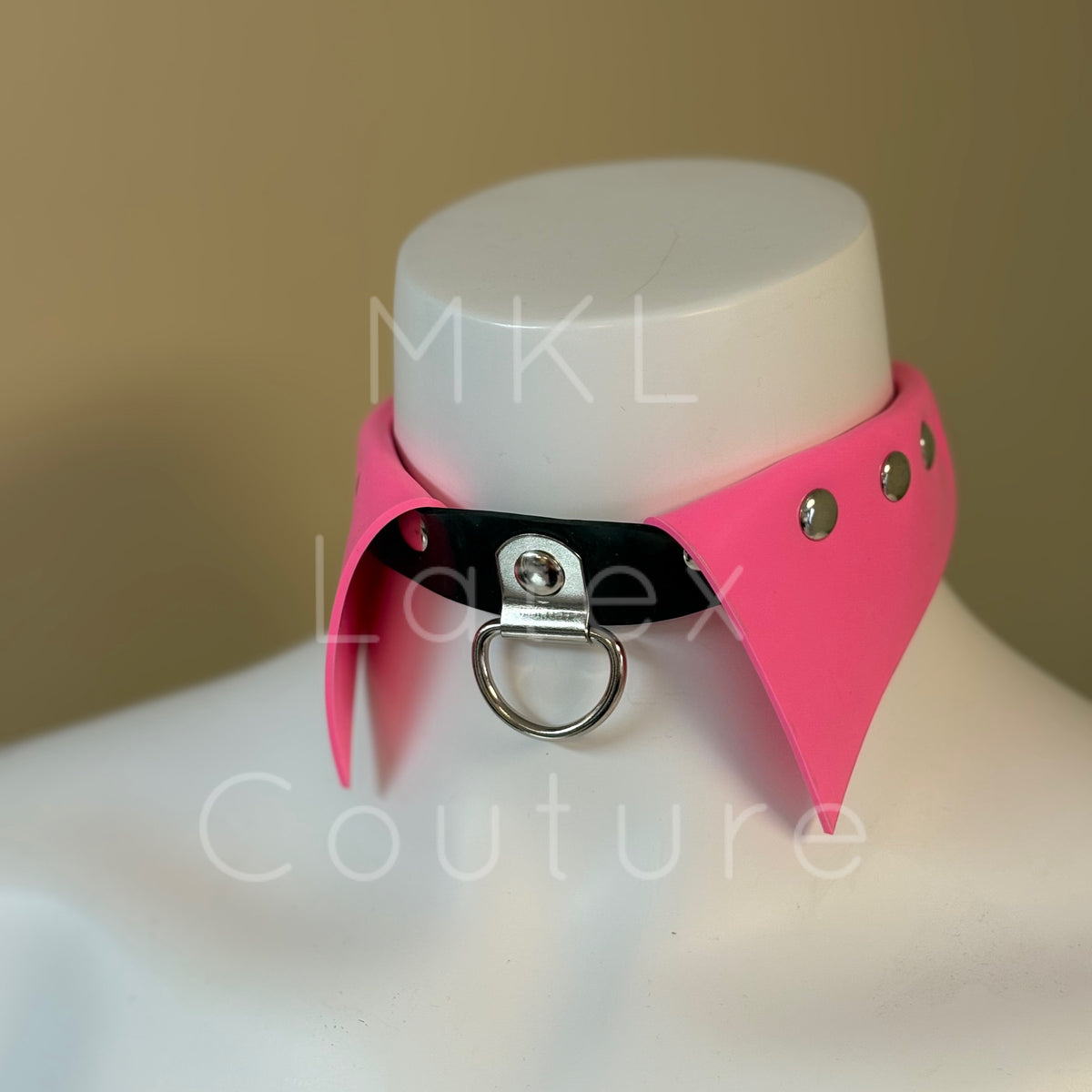 Latex choker collar made with heavy rubber latex. Center D-Ring with metal studs and back buckle for adjustment.