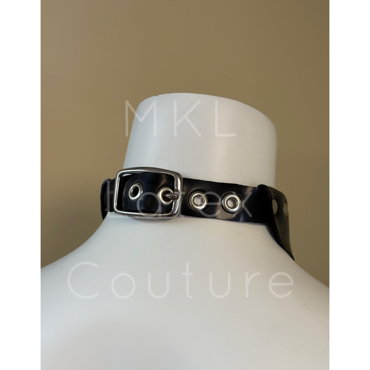 Latex choker collar made with heavy rubber latex. Center D-Ring with metal studs and back buckle for adjustment.