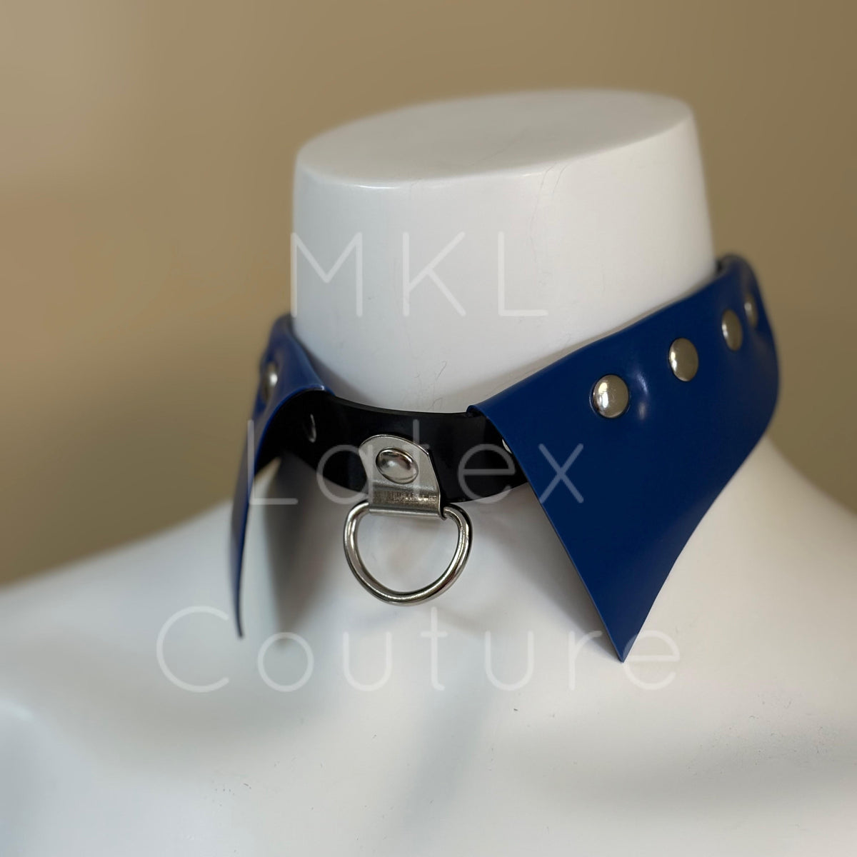 Latex choker collar made with heavy rubber latex. Center D-Ring with metal studs and back buckle for adjustment.
