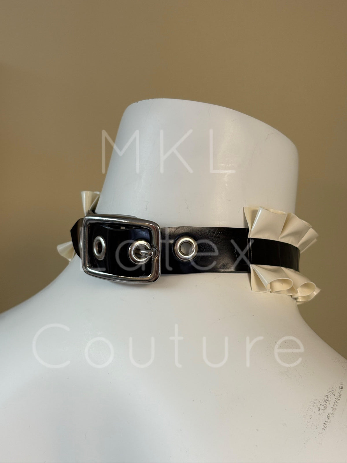 Latex ruffles choker made with heavy rubber latex and soft latex ruffles. Center D-Ring with metal stud and back buckle for adjustment.